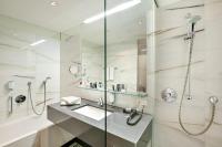 a bathroom with a sink and a shower at Austria Trend Hotel Congress Innsbruck in Innsbruck