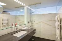 a bathroom with a sink and a shower at Austria Trend Hotel Congress Innsbruck in Innsbruck