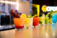 three cocktails sitting on a table in a bar at Ibis Guaratingueta Aparecida - Circuito da Fé in Guaratinguetá
