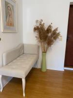 a white couch in a room with a vase with a plant at Apartment Angelina 