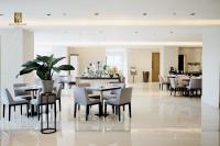 a dining room with tables and chairs and a restaurant at Sotogrande Davao Hotel in Davao City