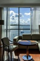 a living room with a couch and a view of the water at Hotel Mikołajki Leisure &amp; SPA in Mikołajki