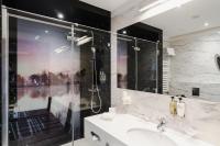 a bathroom with a sink and a shower at Hotel Mikołajki Leisure &amp; SPA in Mikołajki