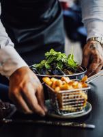 uma pessoa com dois pratos de comida numa mesa em Clarion Hotel Arlanda Airport Terminal em Arlanda