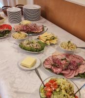 a table with many plates of food on it at Hotel Lilia in Włoszczowa