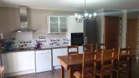 a kitchen with a wooden table and chairs in it at CHEZ ANTOINE in Saint-Pierre-dels-Forcats