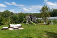 a swing set and a playground in a yard at LA TOULOTTE chez Claire et Christian in Sancy-lès-Provins