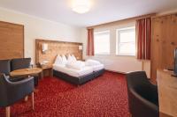 Łóżko lub łóżka w pokoju w obiekcie Hotel Gamsleiten