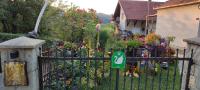 a garden with a gate with a bunch of flowers at Apartmani Mali Raj Rudnik in Rudnik