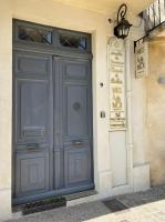 a large blue door on the side of a building at Mes à Moi in Pezenas - Studio &amp; patio privatif - O Pitchoun in Pézenas