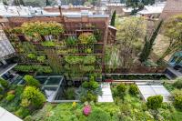 an aerial view of a building with a garden at IOTA Hotel Tbilisi in Tbilisi City