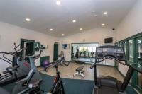 a gym with cardio equipment and bikes in a room at Pugwash Cottage in Falmouth