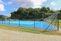 a tennis court with a net on top of it at Pugwash Cottage in Falmouth