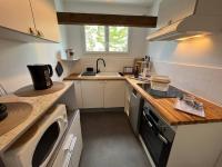 a small kitchen with a sink and a dishwasher at « L’Hilo » Appart 4 Personnes À 250 m de la Plage in Varaville