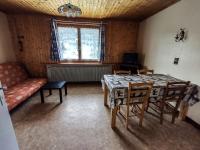 a living room with a table and chairs and a couch at Appartement Les Gets, 3 pièces, 5 personnes - FR-1-671-25 in Les Gets