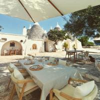 a dining table and chairs in a yard at TRULIVO in Monopoli