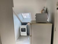 a small kitchen with a stove and a window at Studio confortable centre-ville in Tours