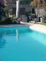 a swimming pool with blue water in a yard at Chambre in Montech