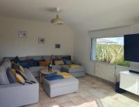 a living room with two couches and a tv at Parenthese relaxante les pieds dans l eau in Le Tour-du-Parc
