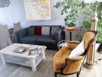 a living room with a couch and a coffee table at Guestroom Briare, 1 pièce, 2 personnes - FR-1-590-369 in Briare