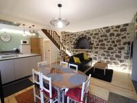 a kitchen and a dining room with a table in a room at Gîte Fontanges, 4 pièces, 6 personnes - FR-1-742-413 in Fontanges