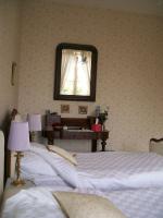 a bedroom with three beds and a mirror on the wall at Manoir Angle in Blanzay-sur-Boutonne