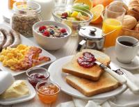 a breakfast table with toast and a plate of breakfast foods at Samui Green Hotel in Chaweng