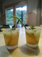 two cocktails sitting on a wooden table at Mas la Llum, la casa de palla in Arens de Lledó