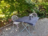 a blue table with two chairs and a bucket on it at le jardin in Montélimar