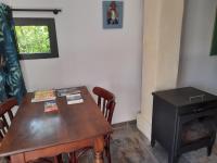 a wooden table and a stove in a room at le jardin in Montélimar