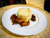 un plato blanco con un trozo de comida en una mesa en Sigiri Holiday Bungalow, en Sigiriya