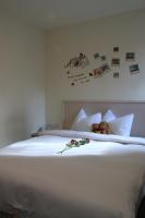 a bed with two teddy bears and flowers on it at Century Hotel in Kaohsiung