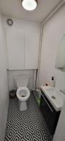 a bathroom with a white toilet and a sink at Austerlitz Cocoon in Paris