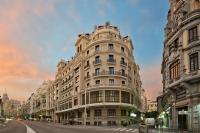 a large building on a city street with a sky at The Principal Madrid, Small Luxury Hotels in Madrid