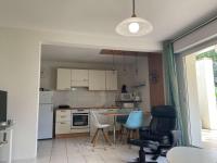 a kitchen with a table and chairs in a room at Appartement Capbreton, 2 pièces, 4 personnes - FR-1-239-872 in Capbreton