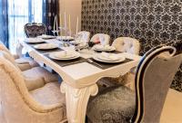 a dining room table with chairs and a white table and chairsktop at Taitung Quality B&amp;B in Taitung City