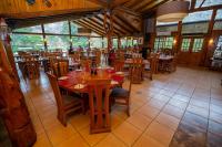 a dining room with wooden tables and chairs at Santuario del Río in San José de Maipo