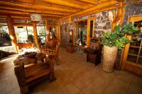 a living room with a table and chairs and a stone wall at Santuario del Río in San José de Maipo