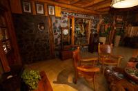 a living room with chairs and a stone wall at Santuario del Río in San José de Maipo