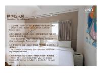 a sign for a room with a bed in a room at Uno Backpackers Inn in Kaohsiung