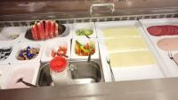 a kitchen with a counter with food and a sink at Hotel Sorella in Ittlingen