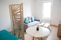 a living room with a couch and a table at Stud confort centre ville 4pers in Saint-Quentin