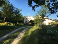 a dirt road in front of a white house at Maison d hôtes Les Chantours dans réserve naturelle 15 hectares in Saint-Antoine-Cumond