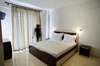 A bed or beds in a room at Rg Status Hotel