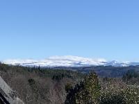 a view of snow covered mountains in the distance at Gîte du Busatier in Marcillac-la-Croisille