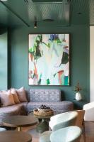 een woonkamer met een bank en een schilderij aan de muur bij Hutton Hotel in Nashville