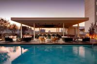 a hotel pool with chairs and a bar at Grand Bohemian Orlando, Autograph Collection in Orlando