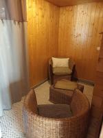 a room with two wicker chairs and a couch at Best Western L&#39;Orangerie in Nîmes
