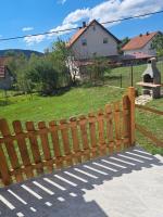 a wooden fence with a field in the background at Lucija in Lovinac