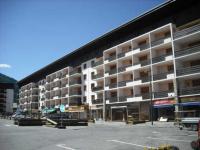 a large parking lot in front of a large building at Appartement Serre Chevalier, 1 pièce, 4 personnes - FR-1-330F-119 in Serre Chevalier